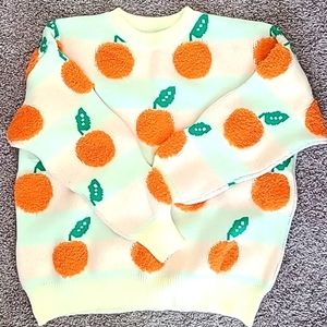 Cream sweater with oranges